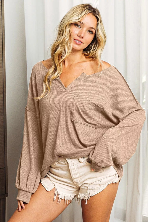 Taupe long sleeve top with V-neck and exposed seams, relaxed fit, front pocket