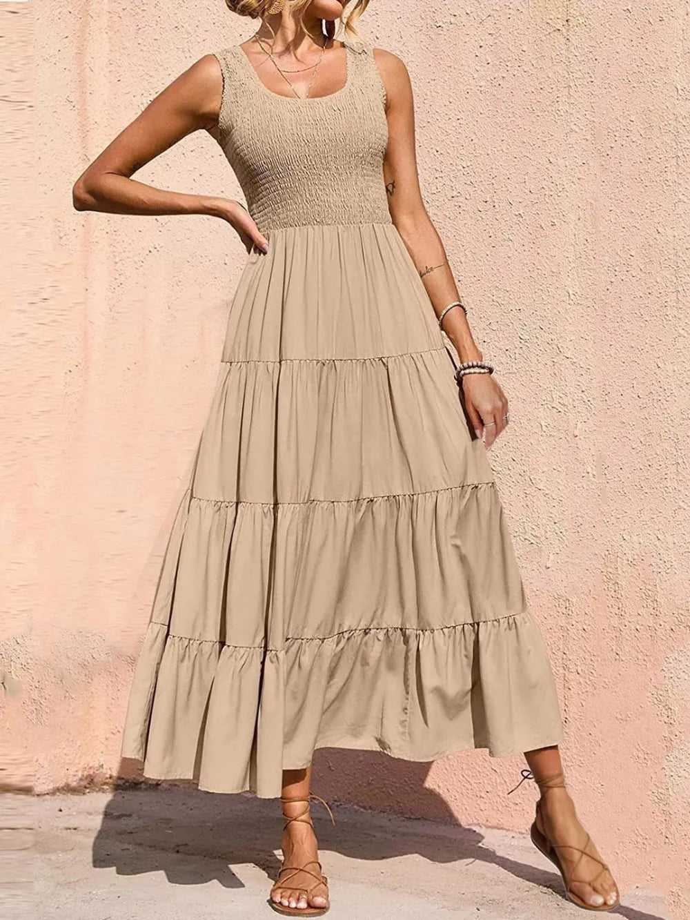 Beige tiered smocked wide-strap dress with sleeveless bodice and tiered ruffle skirt.