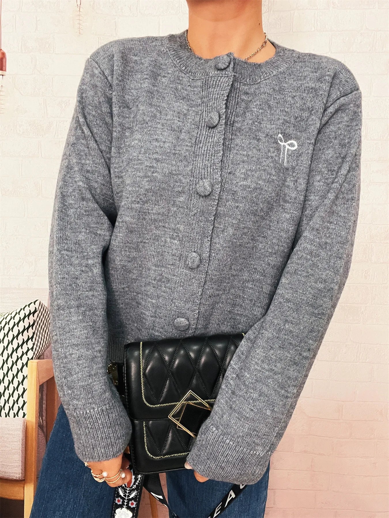 Heather gray button-up long sleeve cardigan with knit texture and button front.