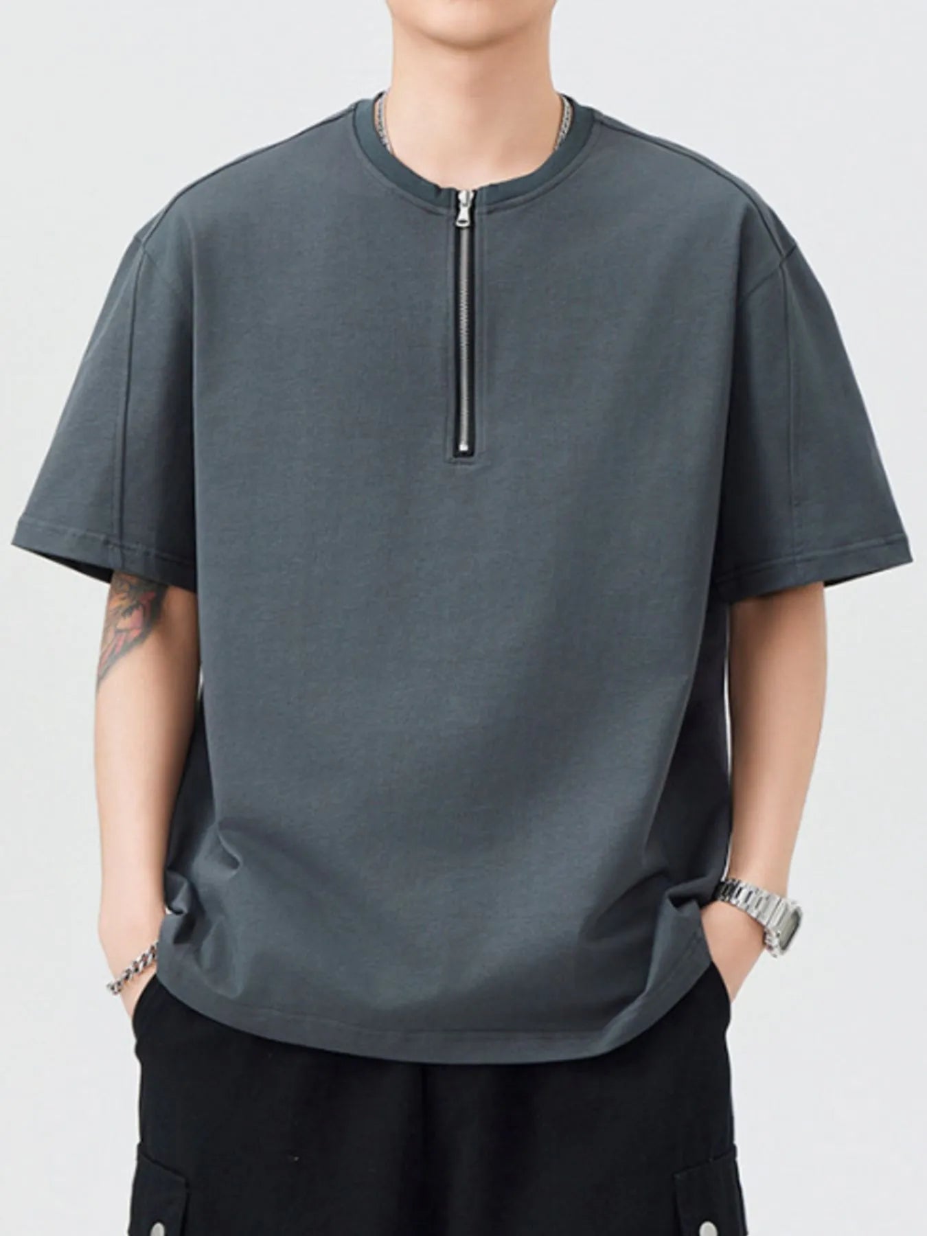 Dark gray oversized half-zip T-shirt with short sleeves and front zipper
