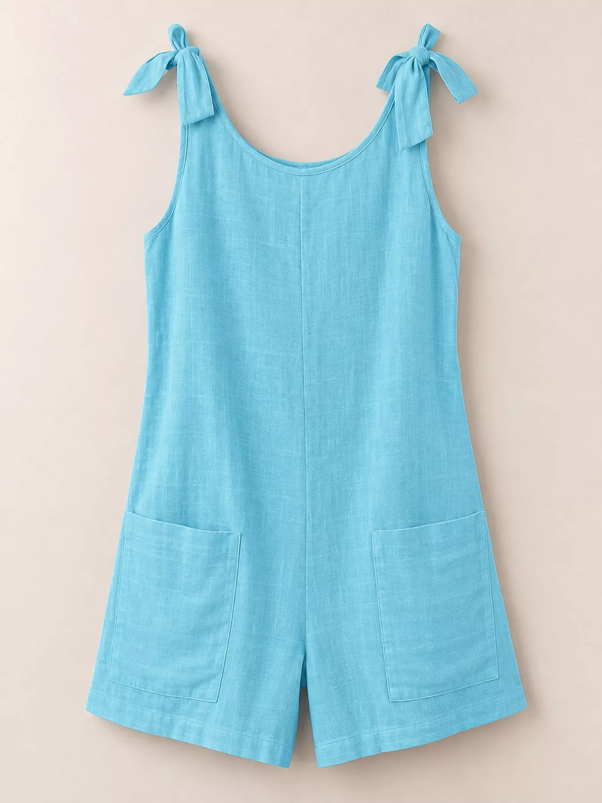 Sky blue tie-shoulder bow romper flat lay with front pockets and wide shorts