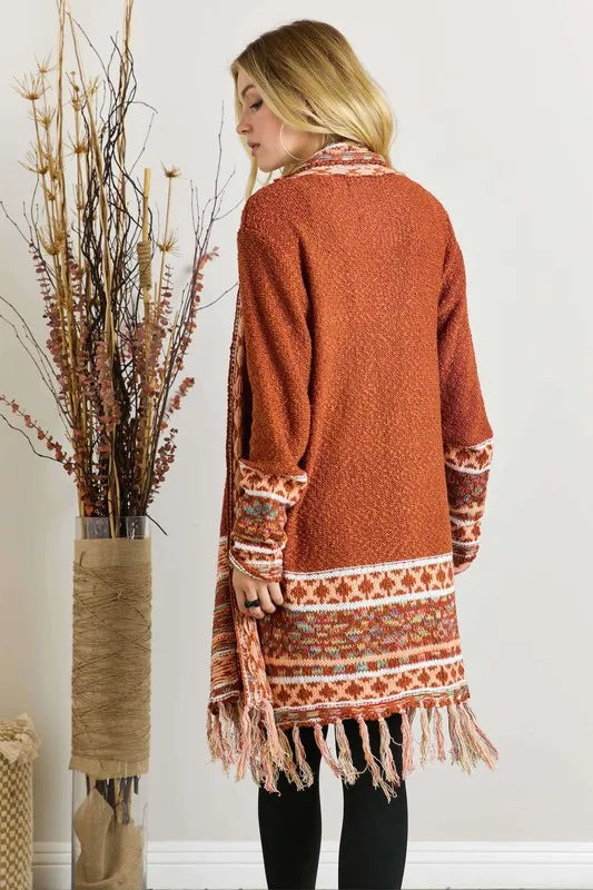 Rust cardigan back view with aztec border and fringe hem
