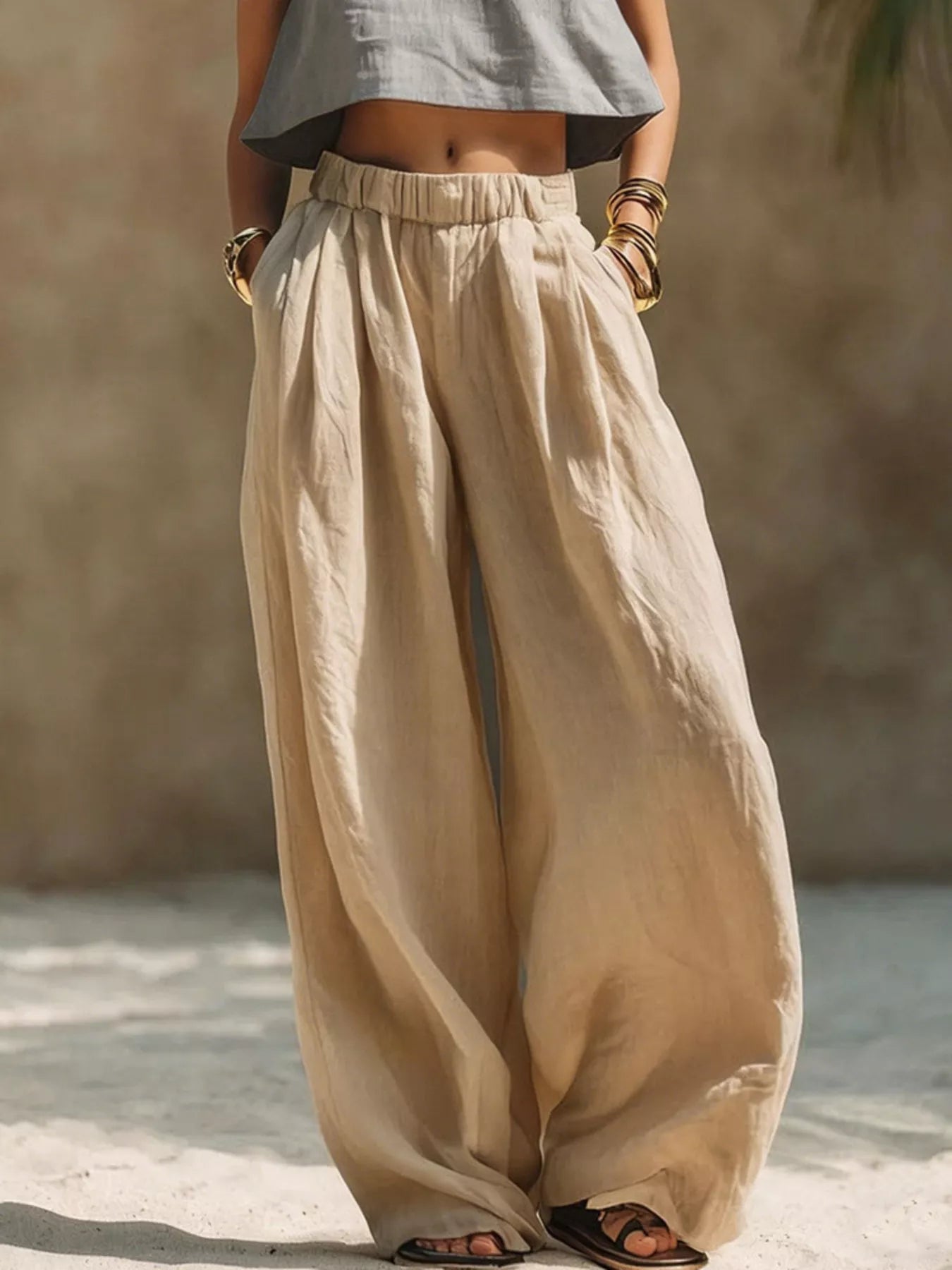 Beige wide-leg pants with elastic waist and gathered front, full-length drape