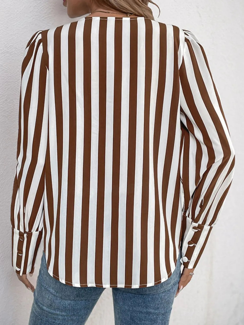 Brown and white striped long-sleeve blouse with round neck and button front detail