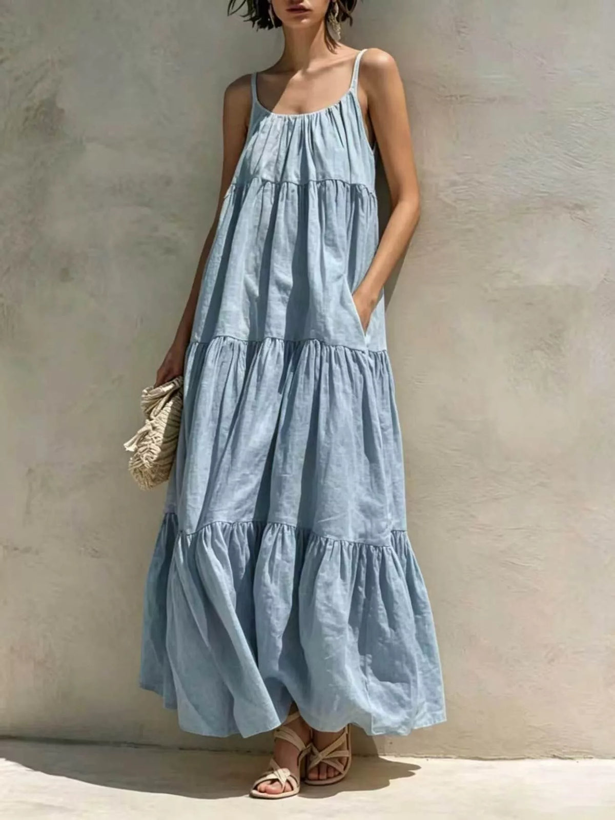 Light blue tiered maxi dress with scoop neckline and sleeveless gathered tiers