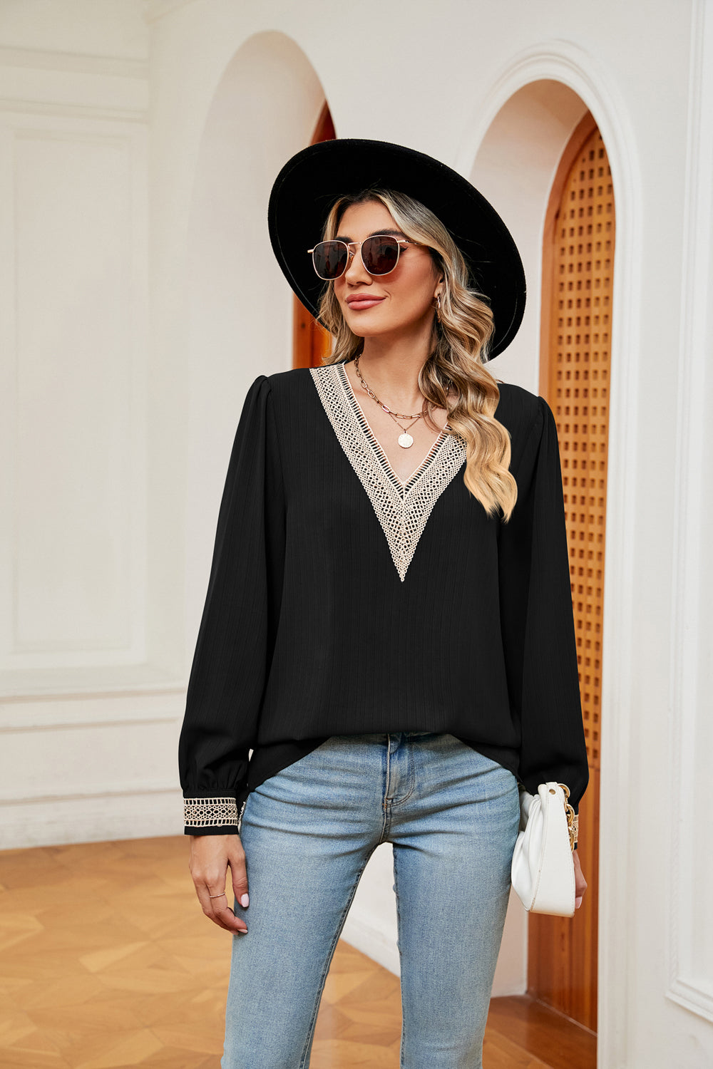 Black blouse with contrast V-neck trim and puff sleeves, elastic cuffs