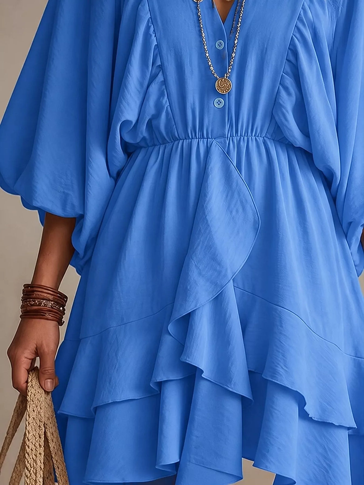 Blue tiered mini dress close-up with gathered waist and layered ruffle skirt