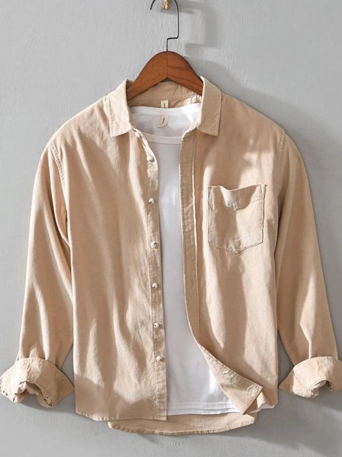 Men's tan cotton button-up shirt with long sleeves, button front, and chest pocket