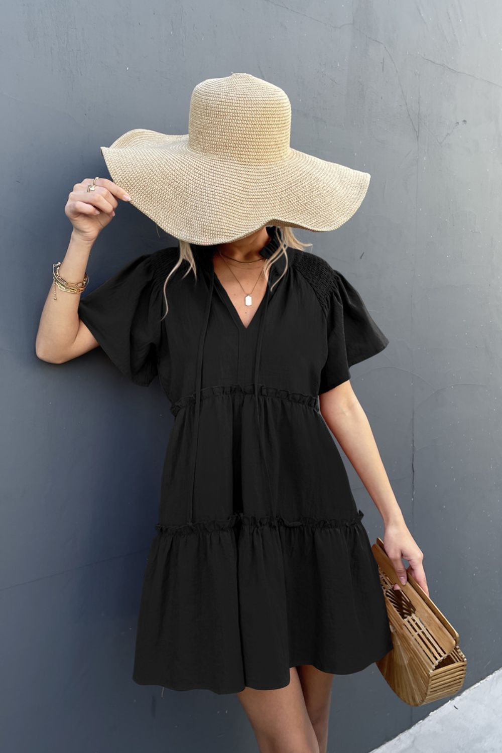 Black smocked tie-neck tiered frill dress with short puff sleeves