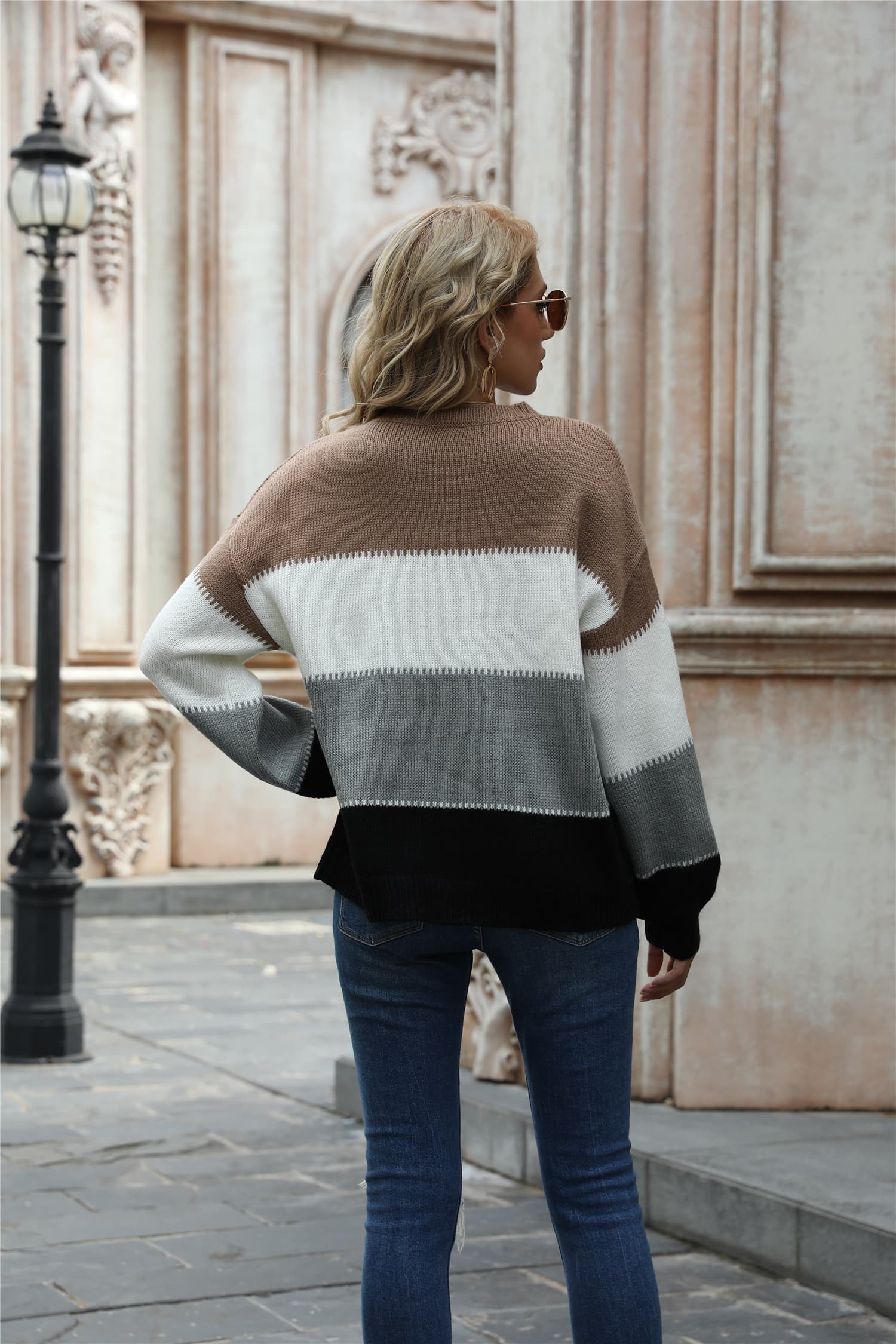 Back view color block round neck sweater in tan, white, dark gray with ribbed cuffs