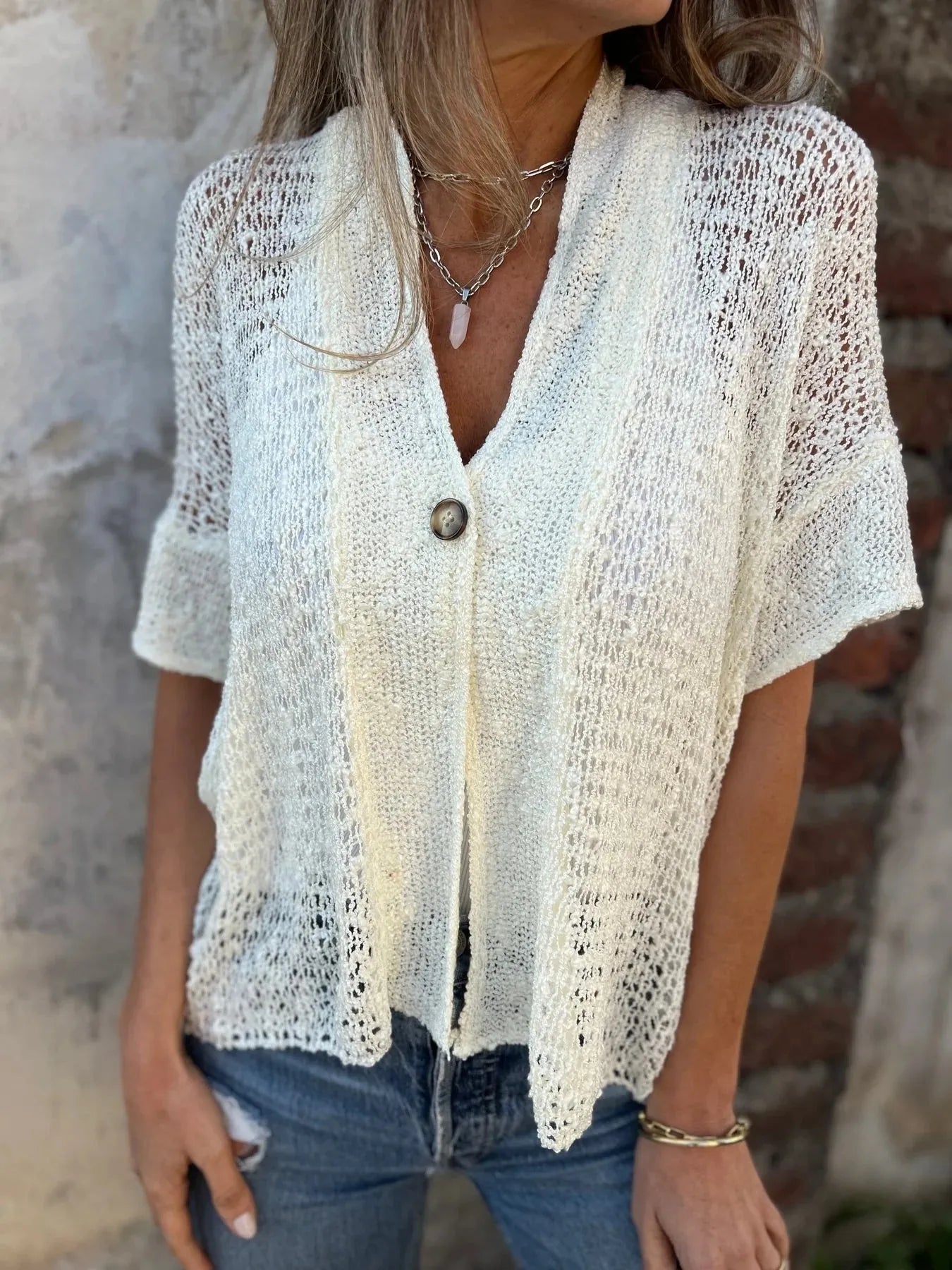 Light cream open-knit one-button half-sleeve cardigan with V-neck and rounded hemline