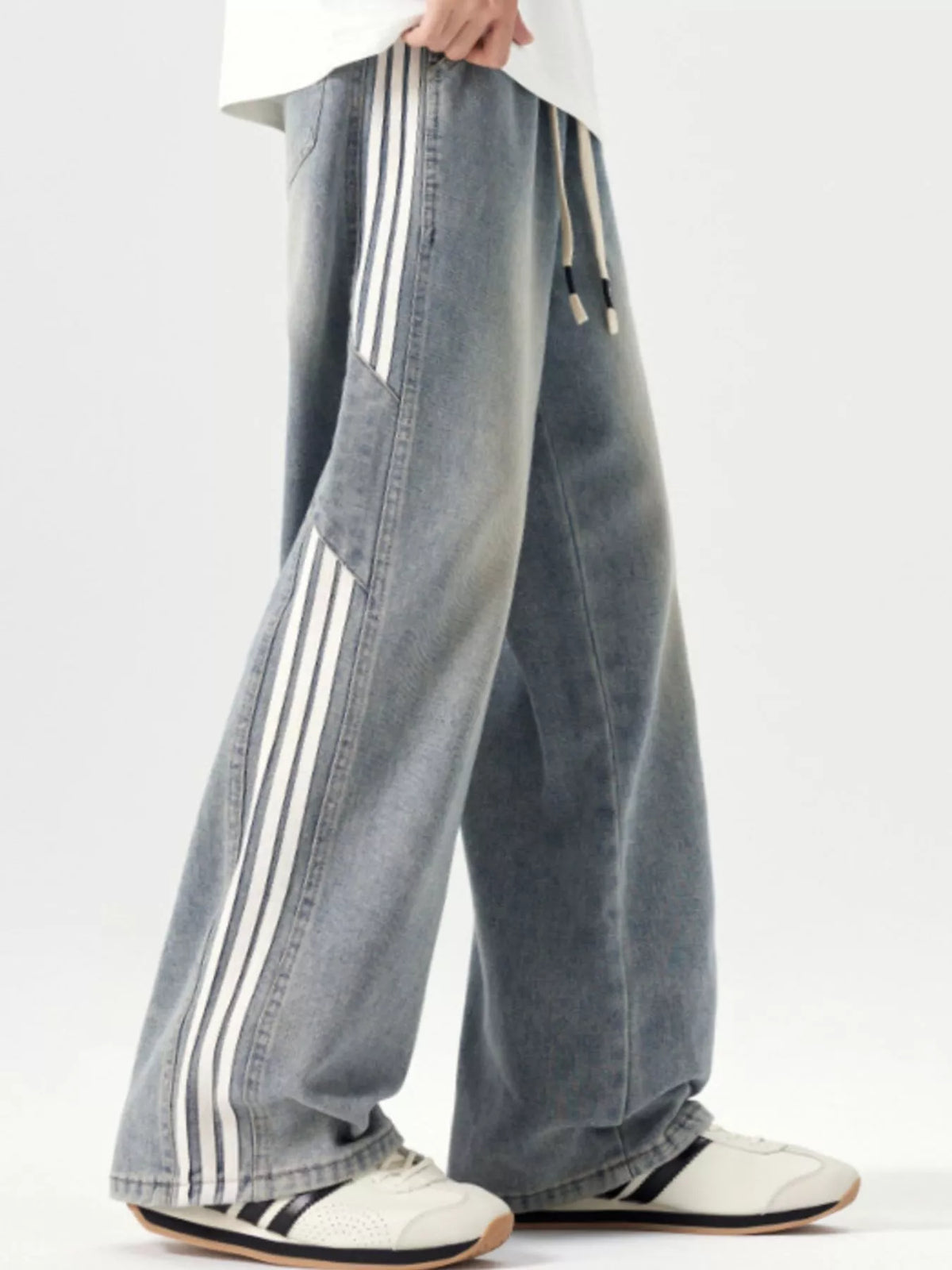 Washed blue wide-leg jeans with drawstring waist and side stripe detail