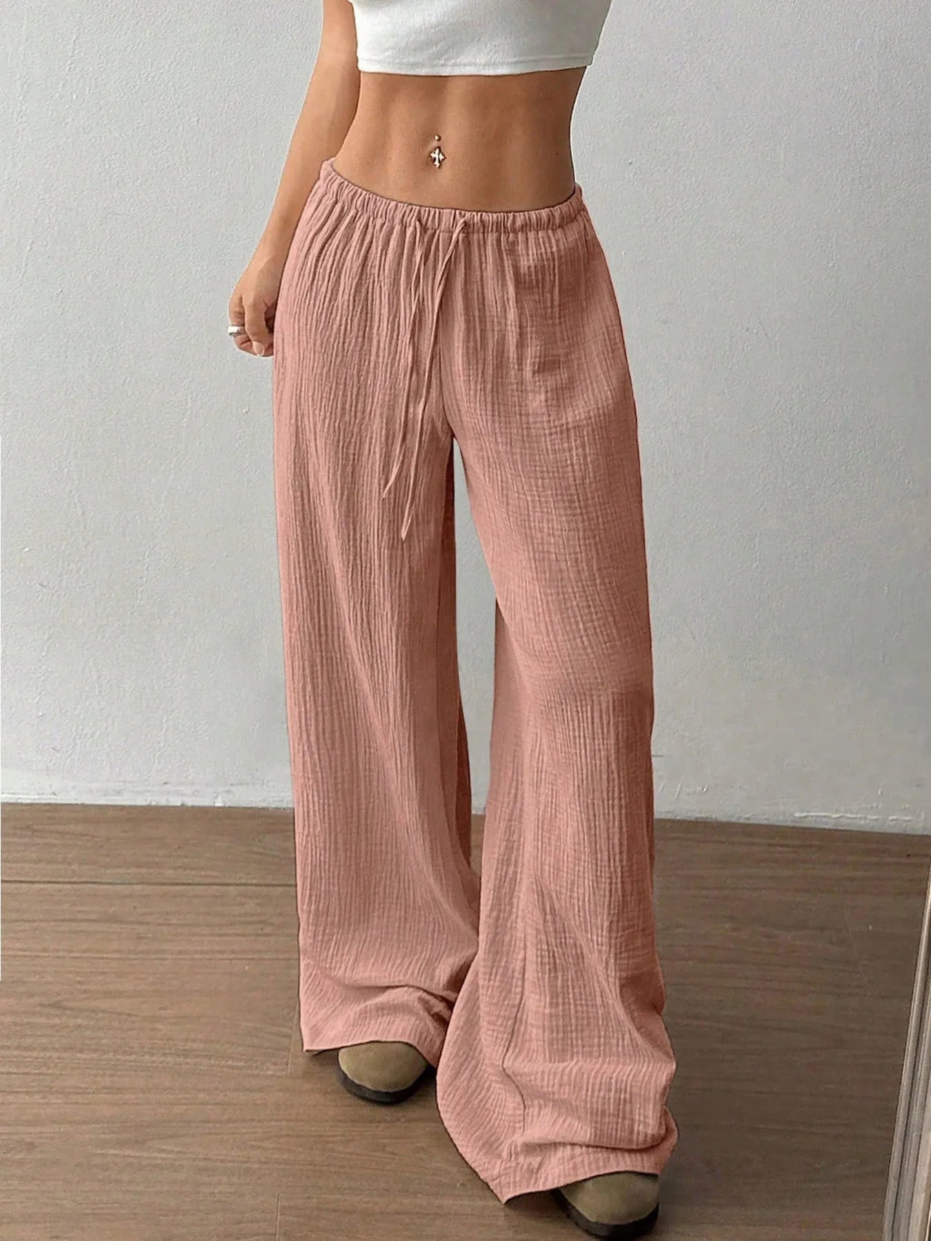 Dusty pink wide-leg drawstring pants with elastic waistband and textured weave