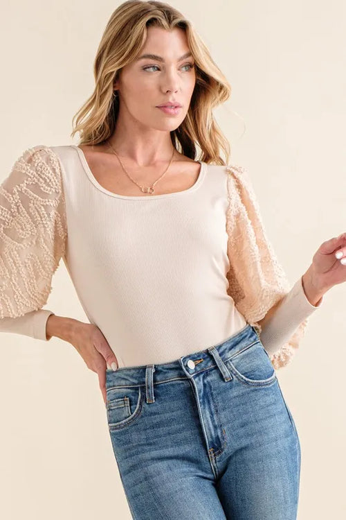 Beige textured ribbed bodysuit with square neckline and lace puff sleeves