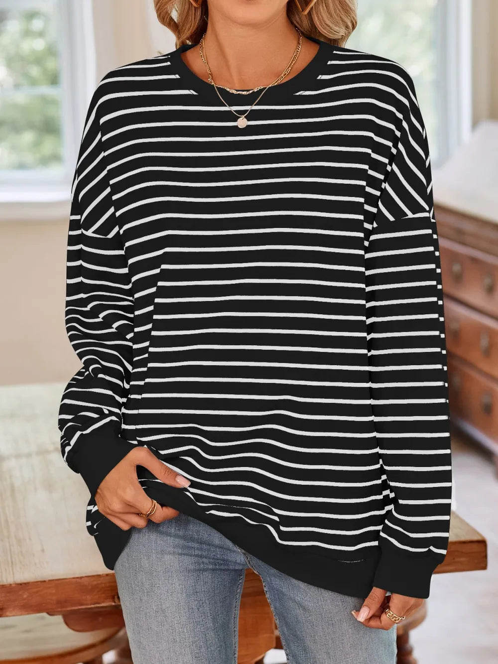 Black striped crew-neck long-sleeve sweatshirt with white horizontal stripes
