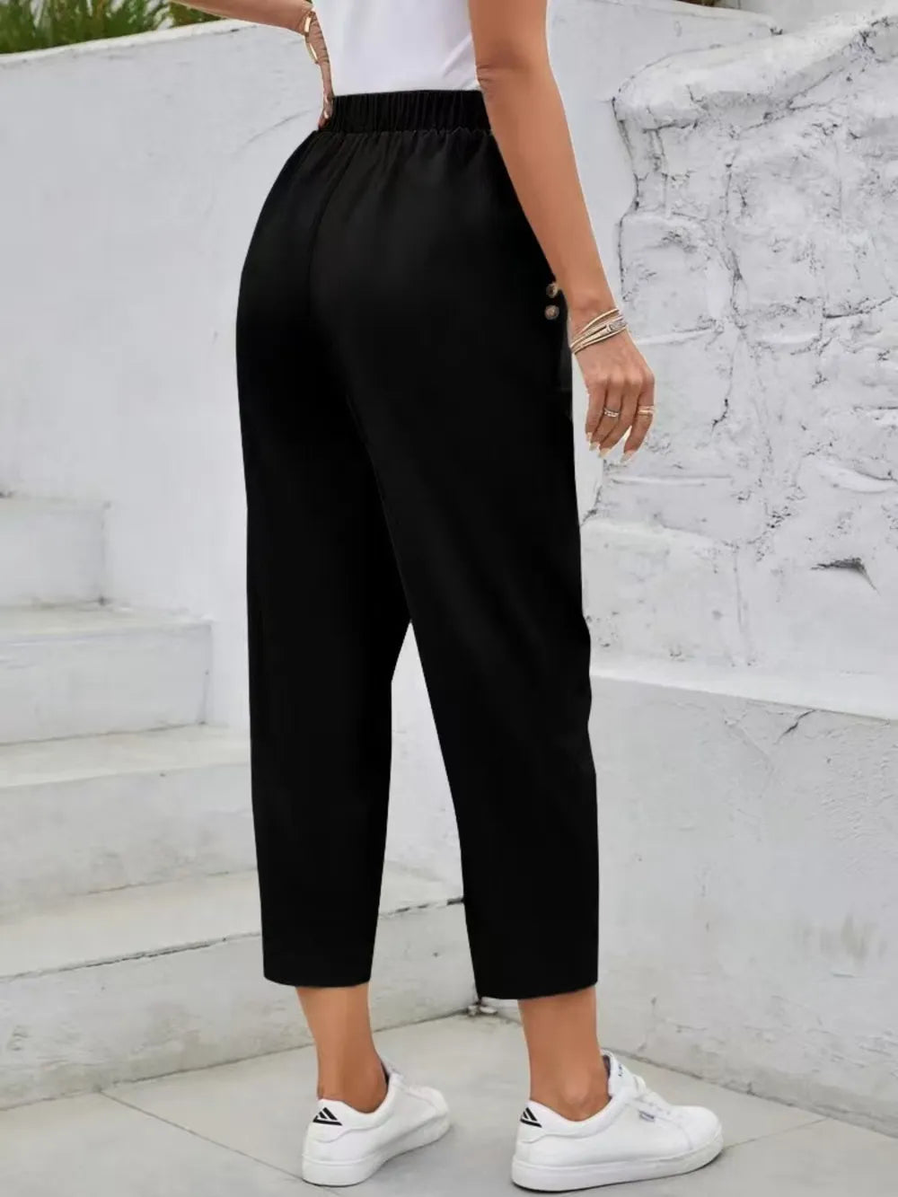 Black high-rise elastic waist pants, relaxed fit, ankle-cropped with side seams