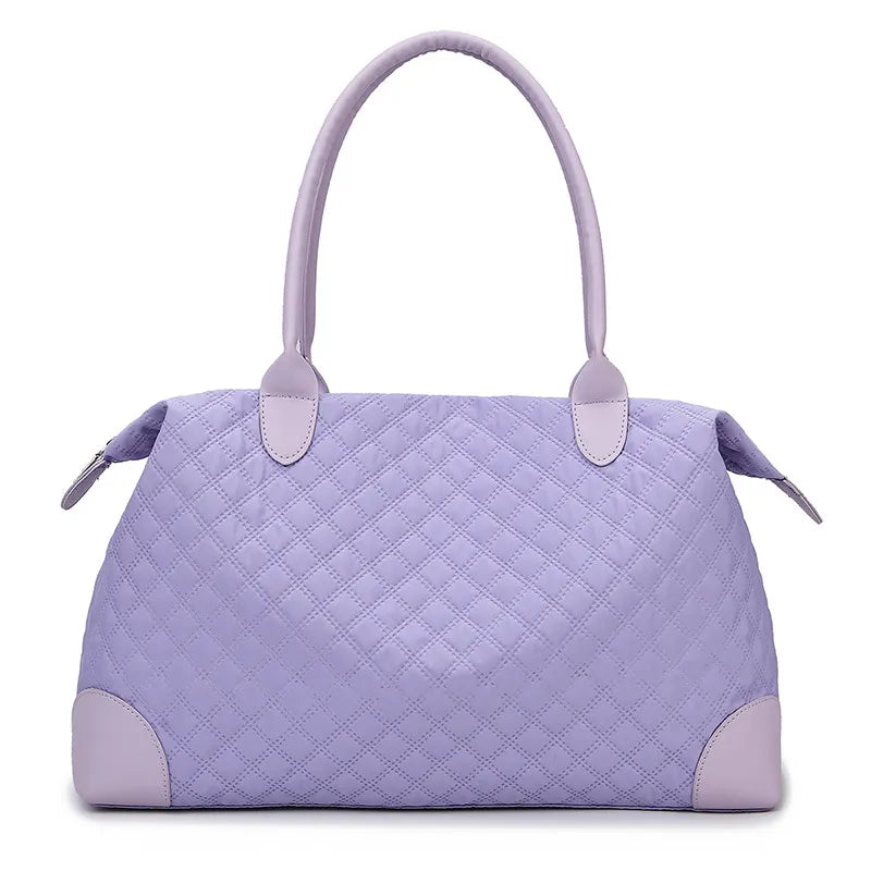 Blue purple quilted travel bag with top handles, side pulls, and zip closure