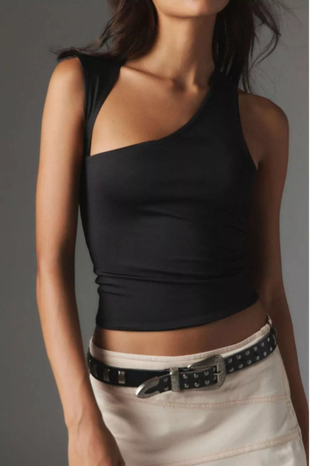 Black asymmetrical sleeveless tank top with scoop neckline, fitted waist