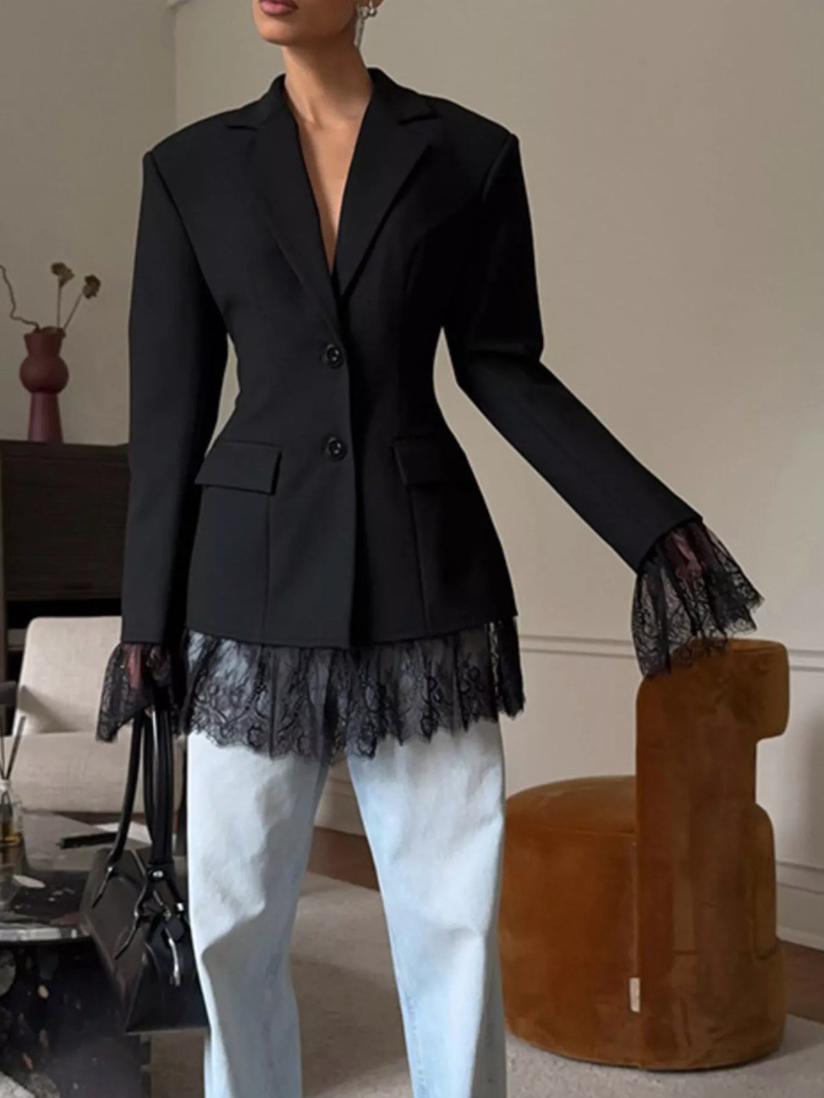 Black lace-hem blazer with notch lapels and flap pockets, front button closure.