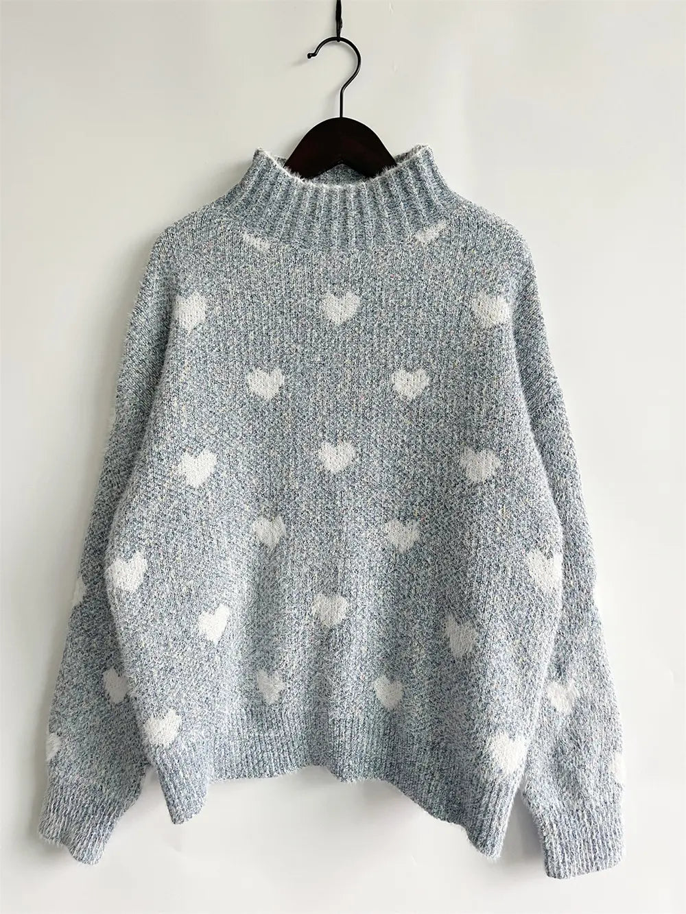 Heart-patterned heathered blue turtleneck drop-shoulder sweater, hanging