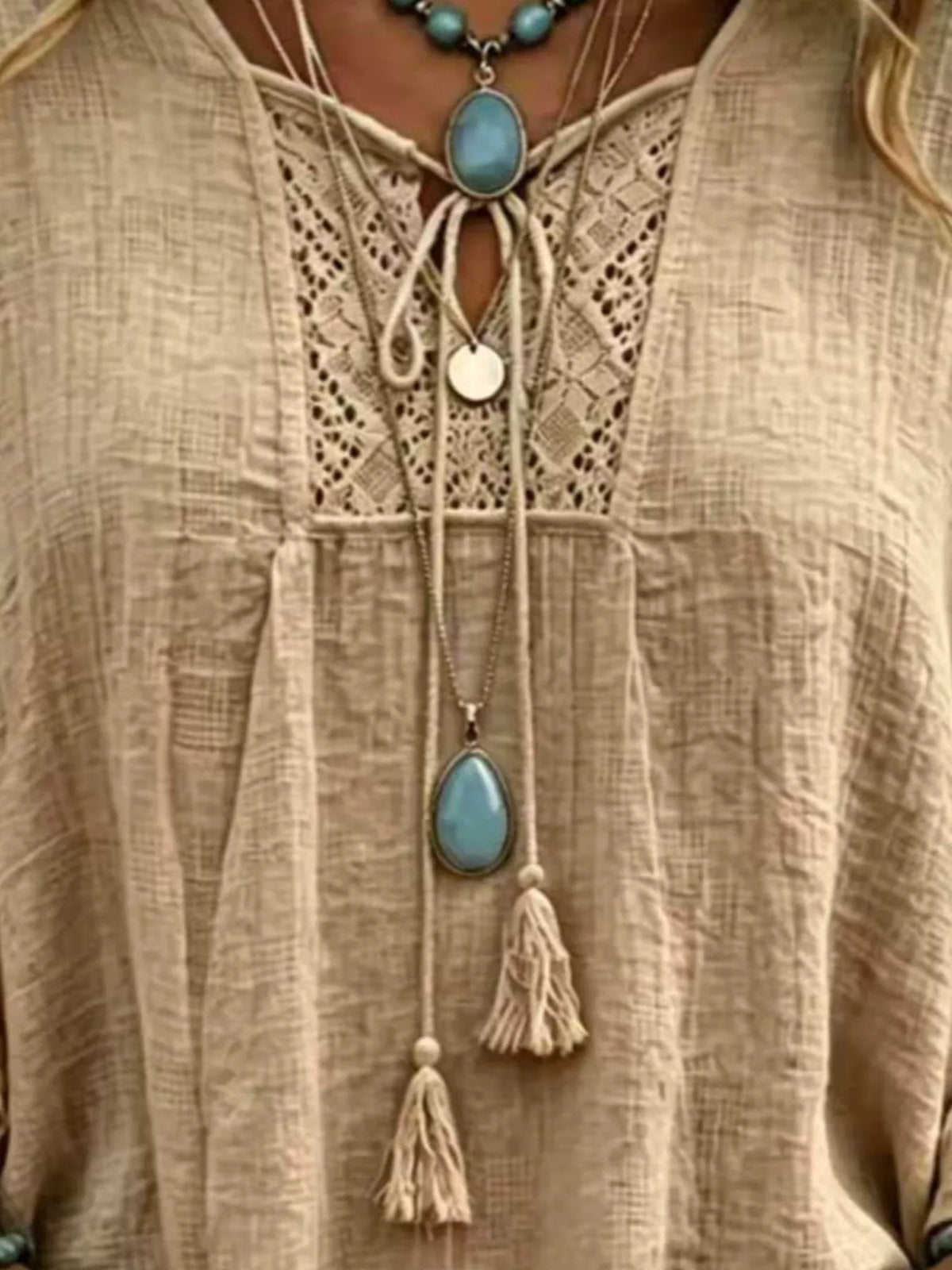 Khaki tie-neck blouse with lace panel and tassel accents at the neckline