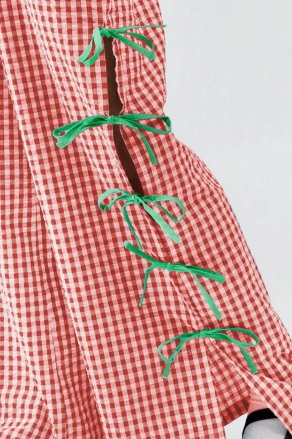 Red plaid pants with green side ribbon ties, close-up tie details