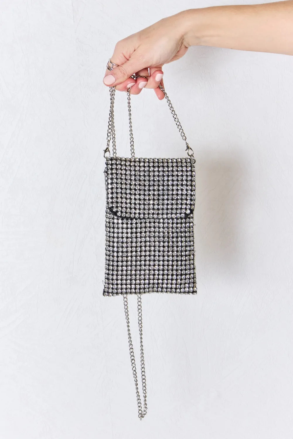 Rhinestone mini crossbody bag with silver chain strap and glittering rectangular front