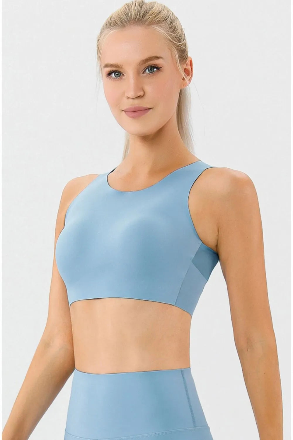 Light blue active bra with round neckline and wide straps, front view