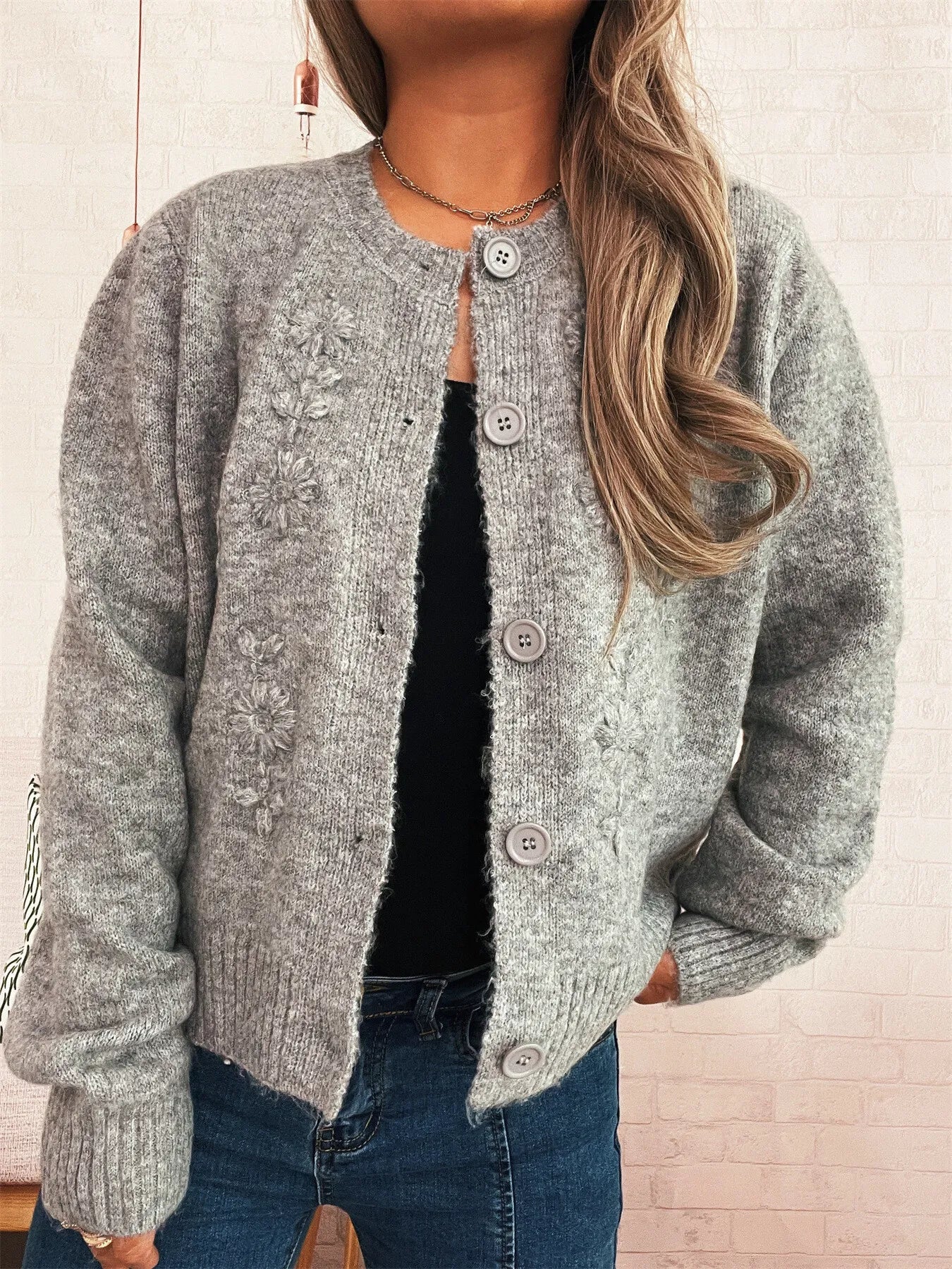 Heather gray cardigan with flower embroidery, button front, and ribbed bottom hem.