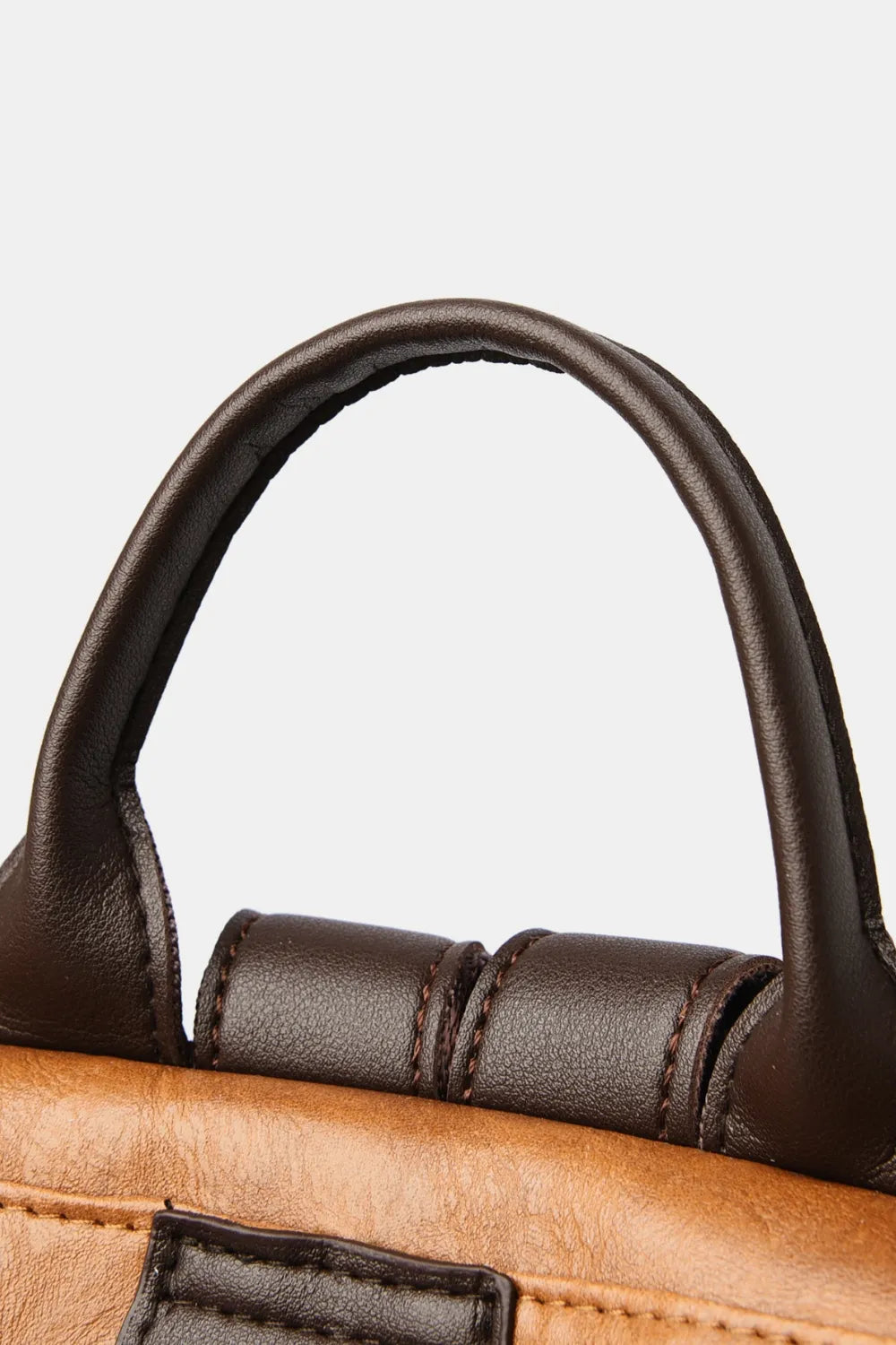 Dark brown top handle loop with stitching on caramel backpack bag