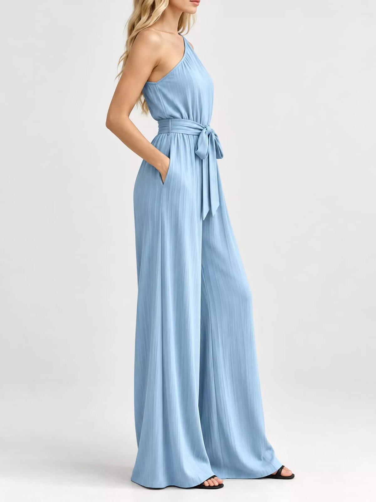 Light blue one-shoulder wide-leg jumpsuit with gathered waist and tie sash
