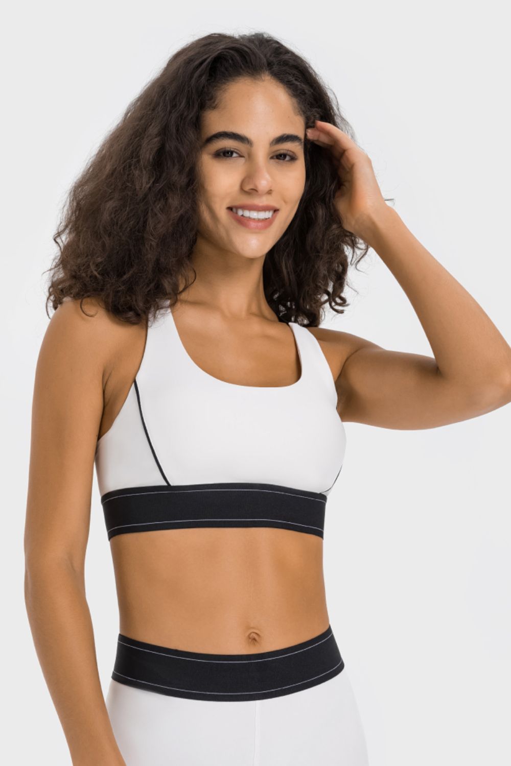 Contrast sports bra in white with black contrast band and scoop neckline