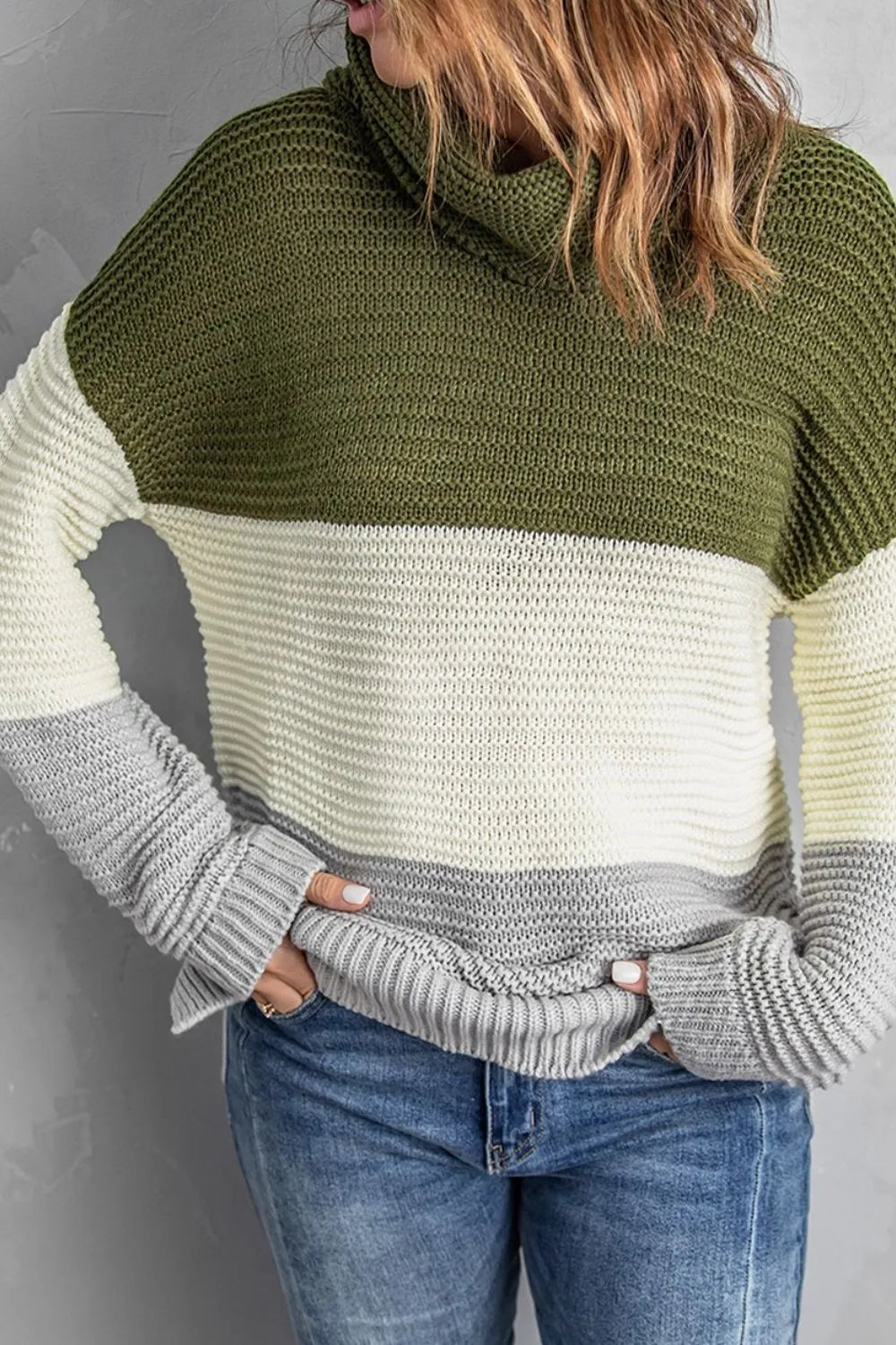 Color-block turtleneck sweater with moss green upper, cream middle, and gray hem