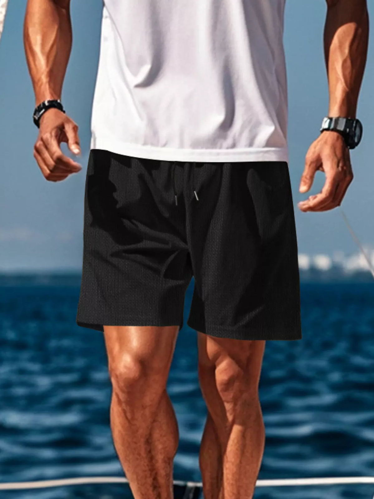 Men's black mid-length drawstring shorts with side pockets