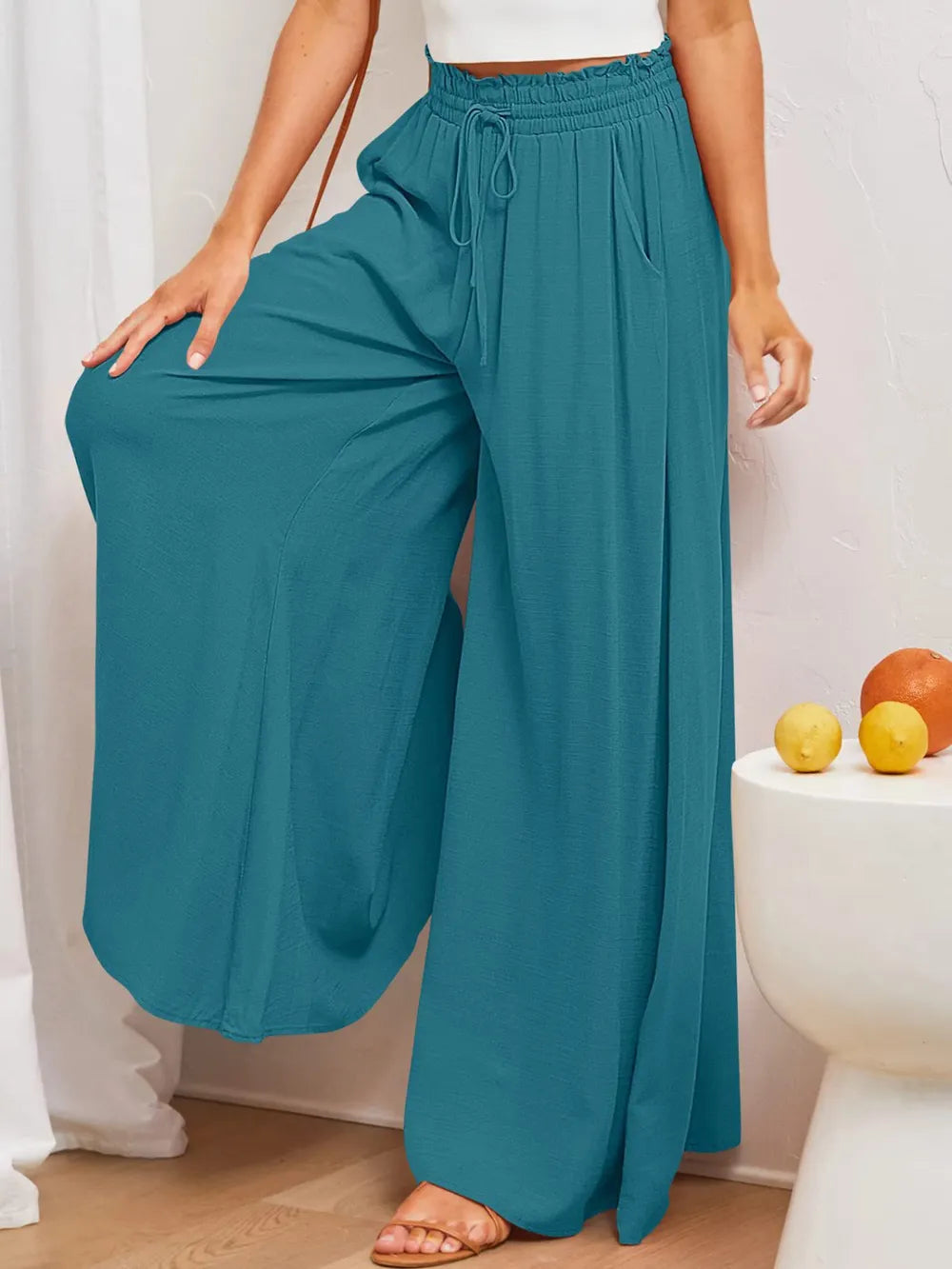 Deep teal wide-leg pants with elastic drawstring waist and relaxed wide legs