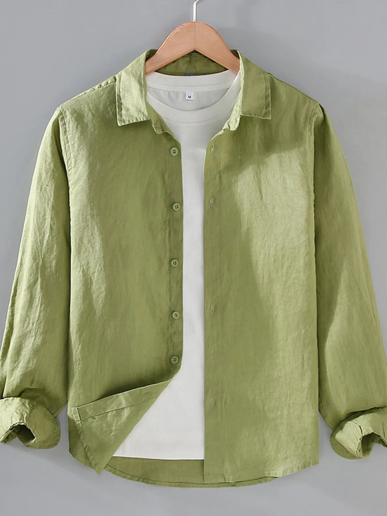 Green button-up long sleeve shirt with front buttons and collared neckline