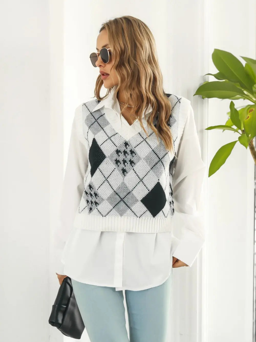 Side view V-neck plaid sweater vest in white with black diamond argyle pattern, sleeveless knit