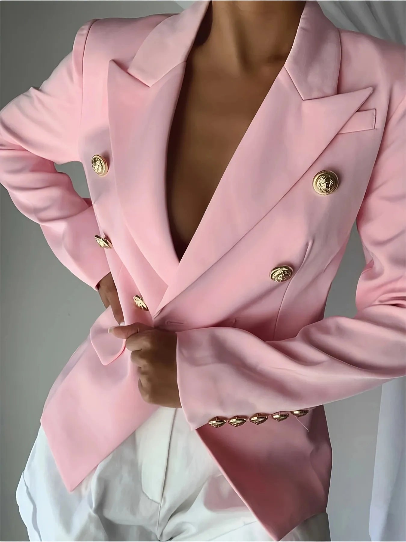 Pink double-breasted blazer with gold buttons and front flap pockets