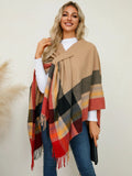 Plaid contrast poncho with fringe trim in tan, black, red, and navy stripes