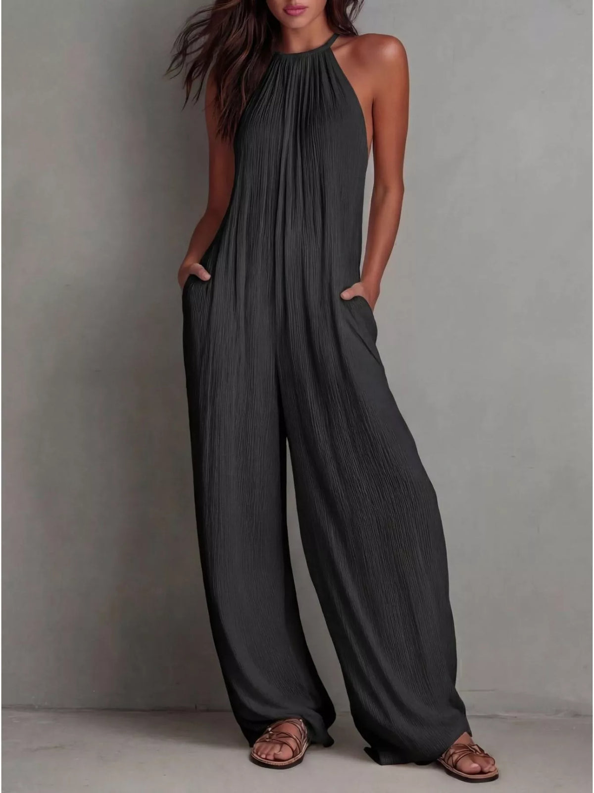 Sleeveless wide-leg jumpsuit in dark gray, halter neckline with pleated drape, wide legs