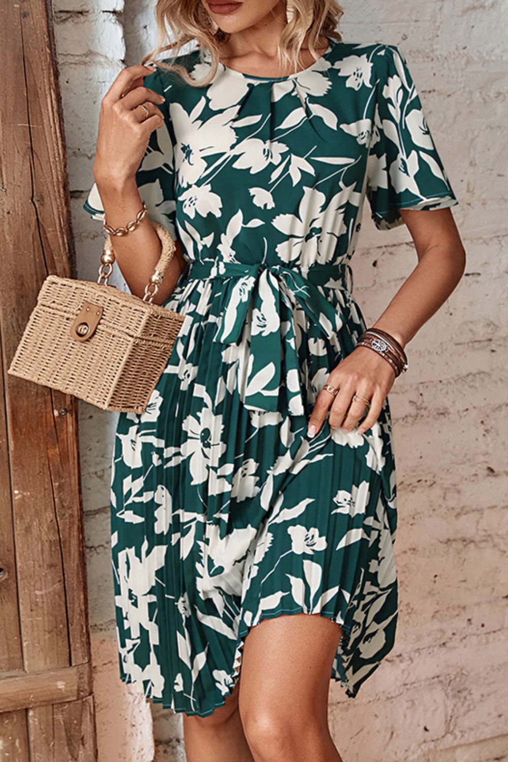 Forest green floral pleated dress with round neck and tied waist belt, short flared sleeves