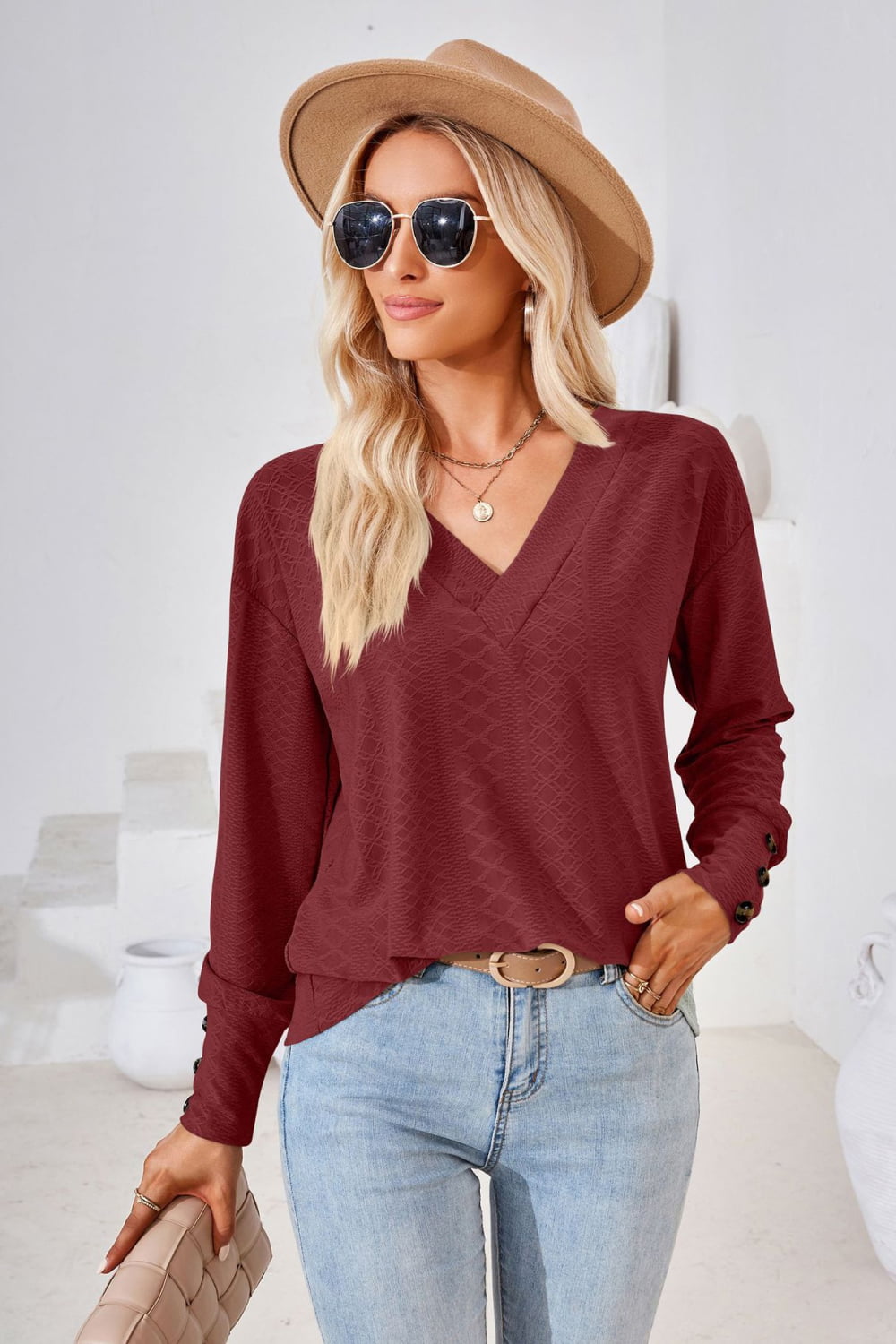 Burgundy V-neck long-sleeve blouse with textured knit and cuffed sleeves