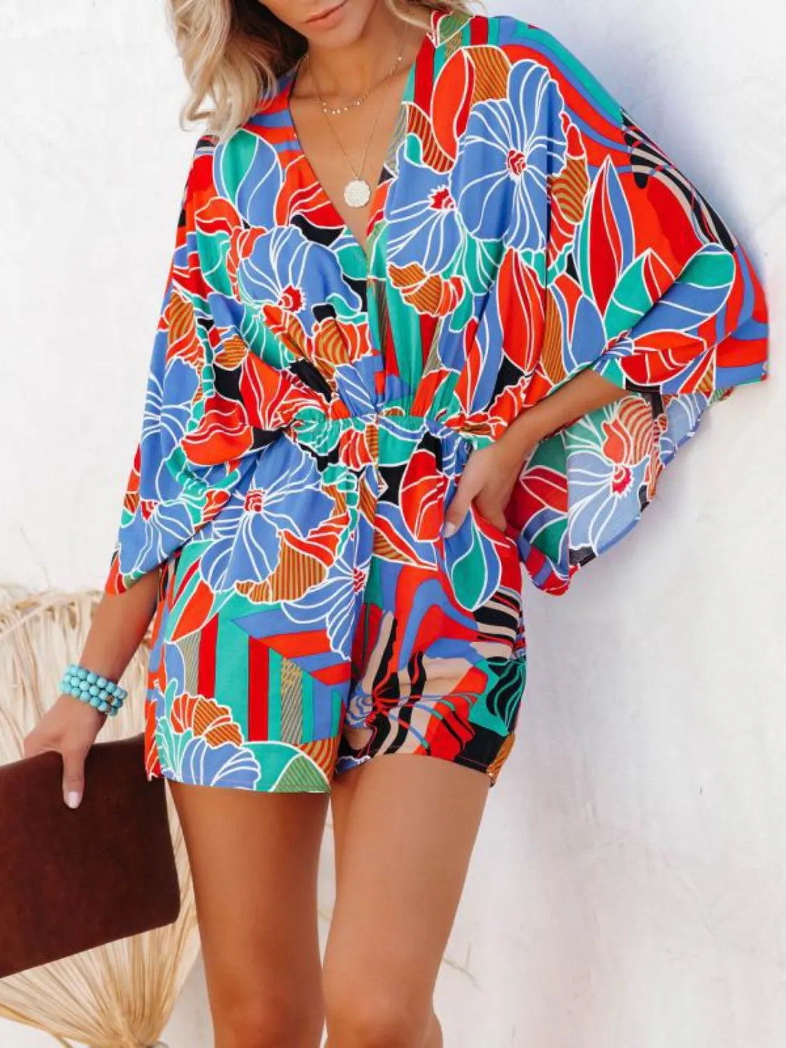 Floral printed romper with V-neck, elastic waist, and loose long sleeves