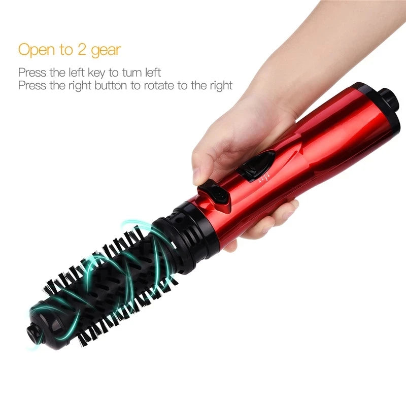 Red hair dryer brush with rotating brush head close-up held in hand
