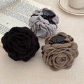 3-pack fabric rose hair claw clips: black, gray, and beige on metal pin bars
