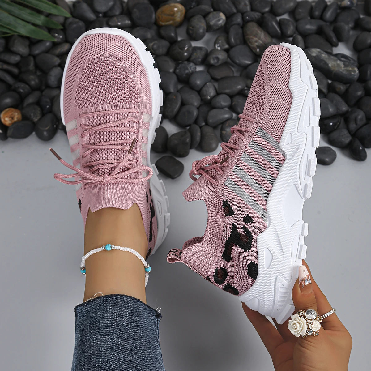 Women's pink leopard-print athletic sneakers with breathable knit upper and thick white soles (two shoes)