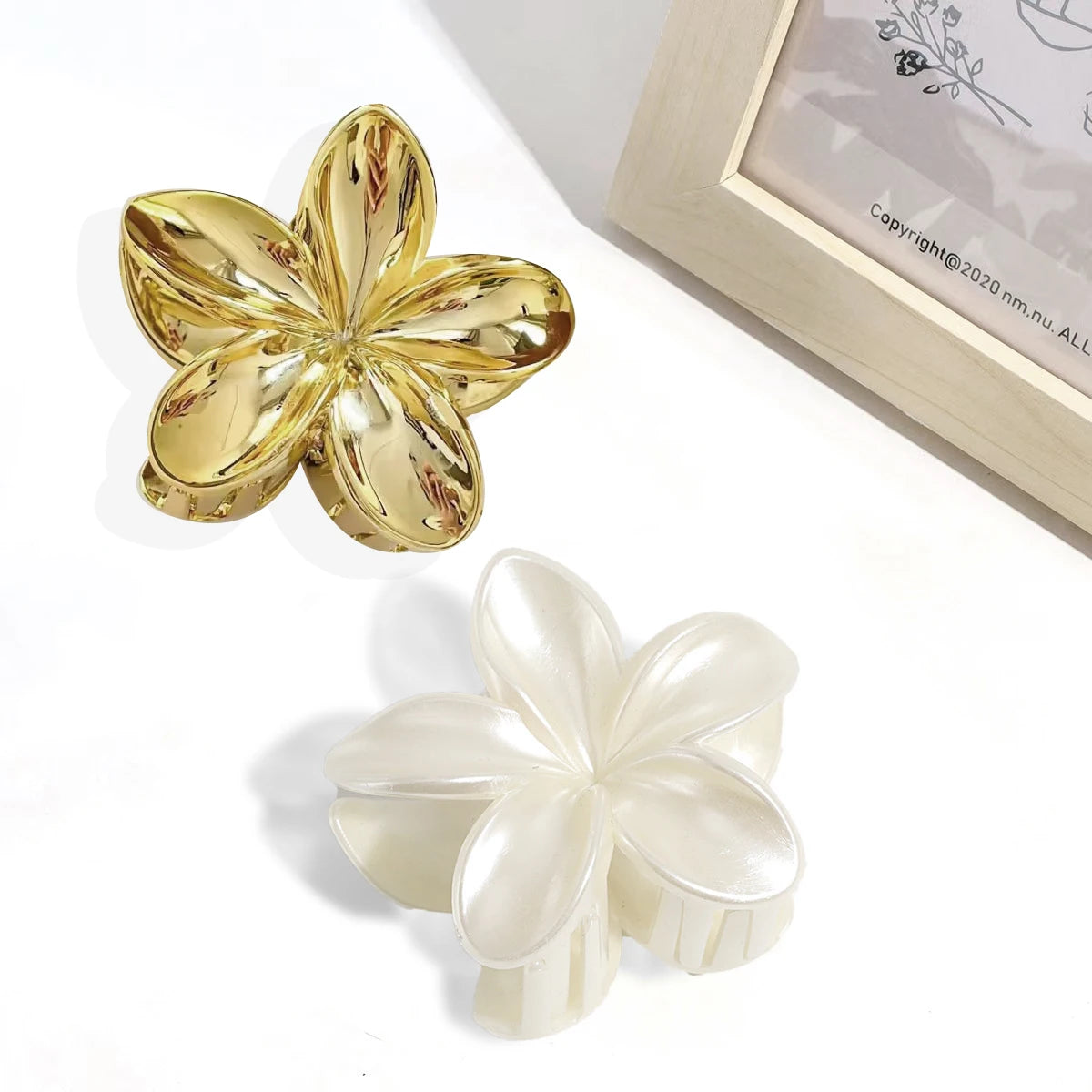 Gold and white flower hair claw clips with glossy five-petal design