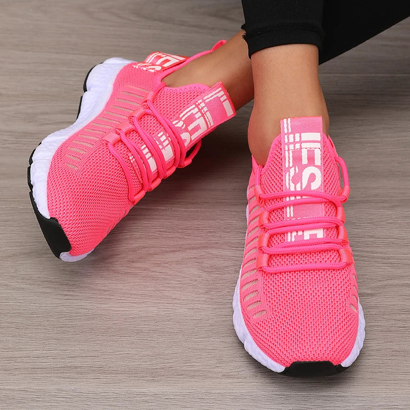 Lightweight running shoes in pink with white soles and lace-up straps