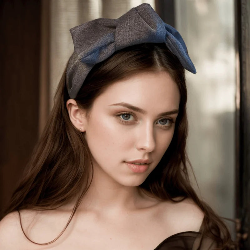 Grey wide bow headband with fabric knot, worn and centered