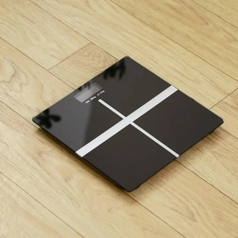 Digital bathroom scale with LED display, black glass top and white cross design